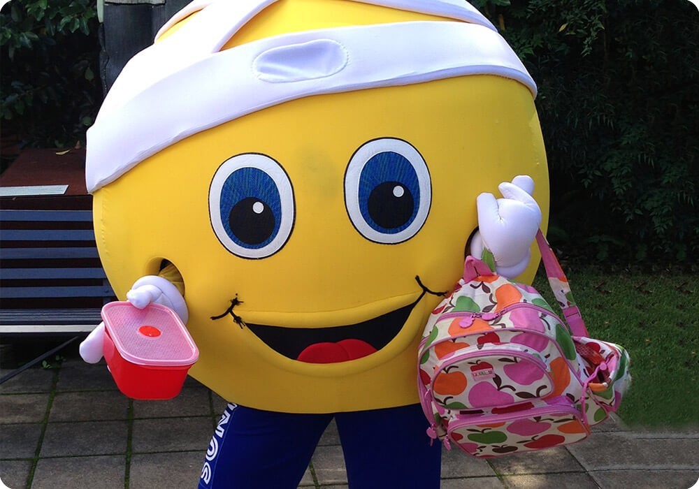 Sydney Children's Hospital Mascot, Sunny holding a lunchbox and backpack ready for school Sydney Children's Hospital Mascot, Sunny holding a lunchbox and backpack ready for school