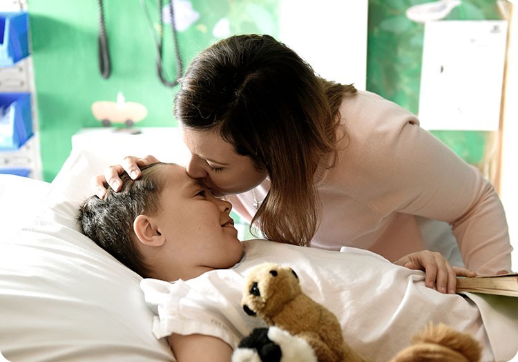 Owen being kissed on the forehead by his mother at Sydney Children's Hospital Owen being kissed on the forehead by his mother at Sydney Children's Hospital