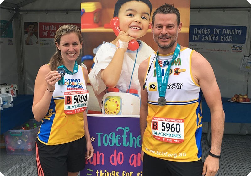 Runner Jess and Luke for Sydney Children's Hospital Foundation at the finish line of Blackmores Running Festival Runner Jess and Luke for Sydney Children's Hospital Foundation at the finish line of Blackmores Running Festival